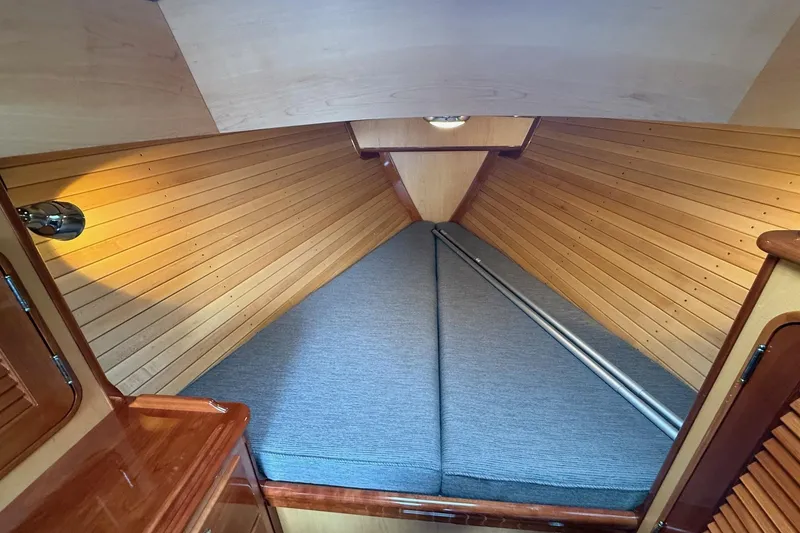 Slide: The Image of Interior cabin of 2015 Hinckley DS 42 yacht with wooden paneling and cozy bedding. - 58