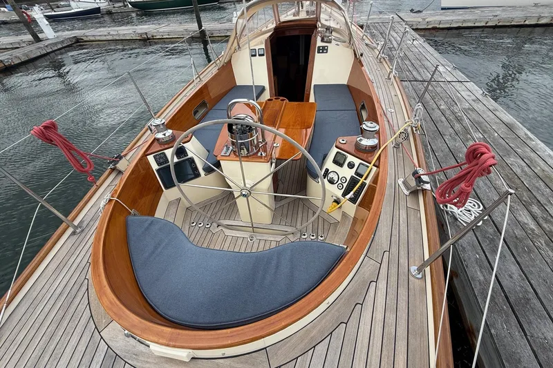 Slide: The Image of Hinckley DS 42 sailboat cockpit, 2015 model, docked with wooden deck and steering wheel. - 7