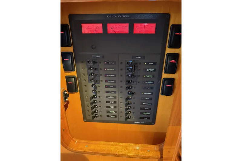 Slide: The Image of Electrical control panel on a 2015 Hinckley DS 42 boat, featuring switches and gauges. - 73