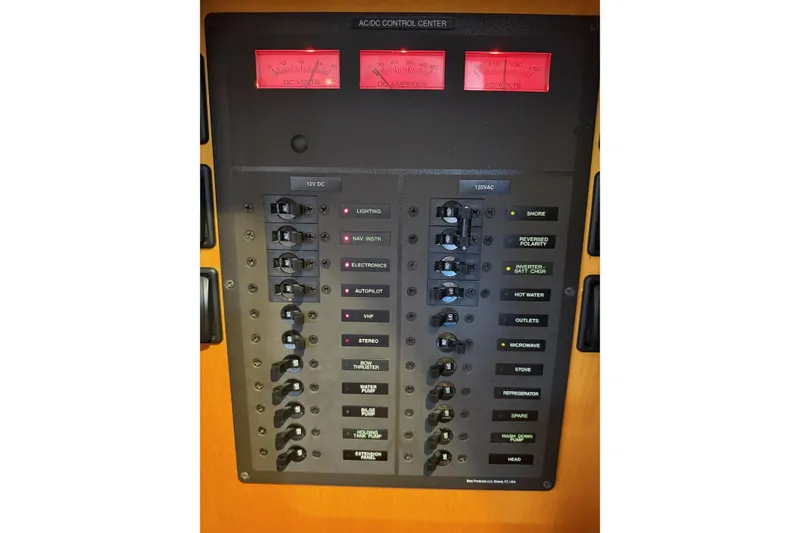 Slide: The Image of Hinckley DS 42 2015 electrical control panel with switches and voltage meters. - 74