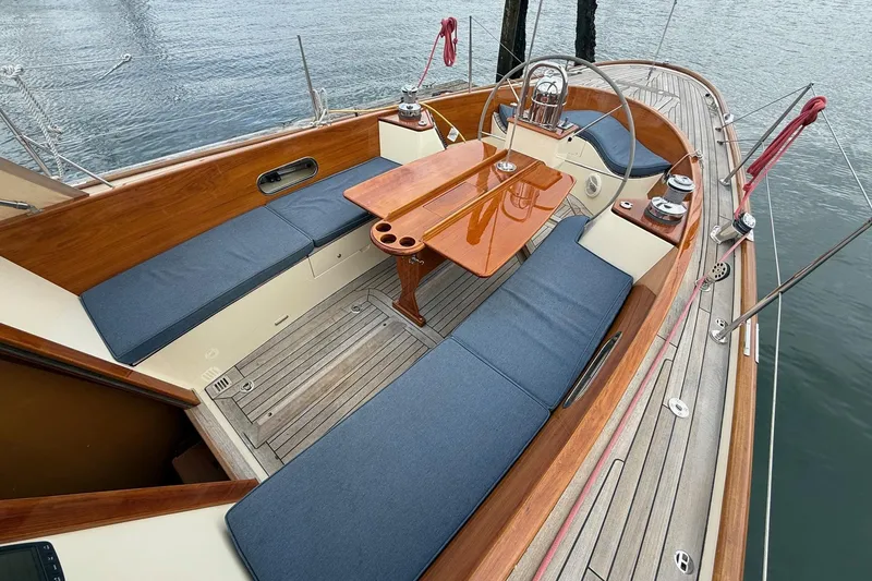 Slide: The Image of Hinckley DS 42 sailboat cockpit, 2015 model, featuring wooden accents and blue cushioned seating. - 9