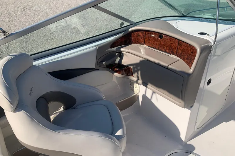 Slide: The Image of 2003 Four Winns 240 Horizon boat interior with helm and seating area. - 10