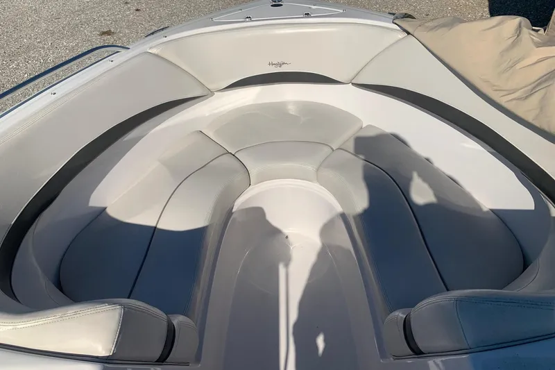 Slide: The Image of 2003 Four Winns 240 Horizon boat interior with cushioned seating and shadows. - 13