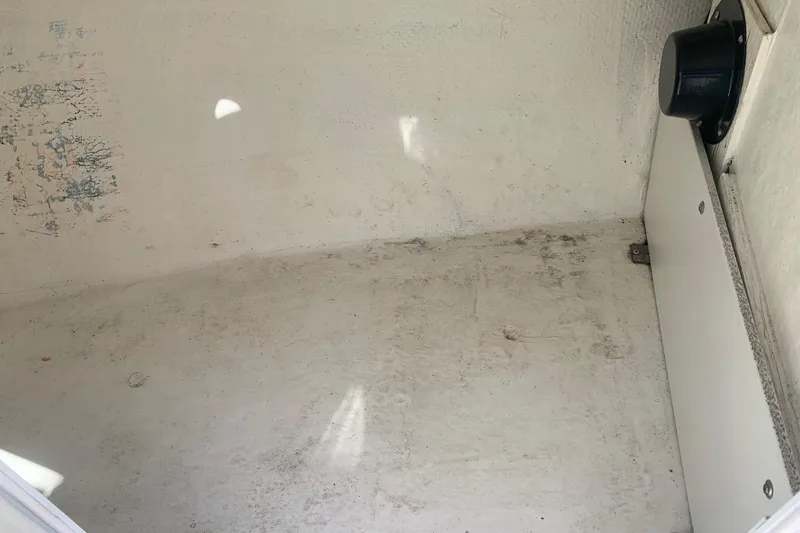 Slide: The Image of Storage compartment of a 2003 Four Winns 240 Horizon boat, showing interior details. - 16