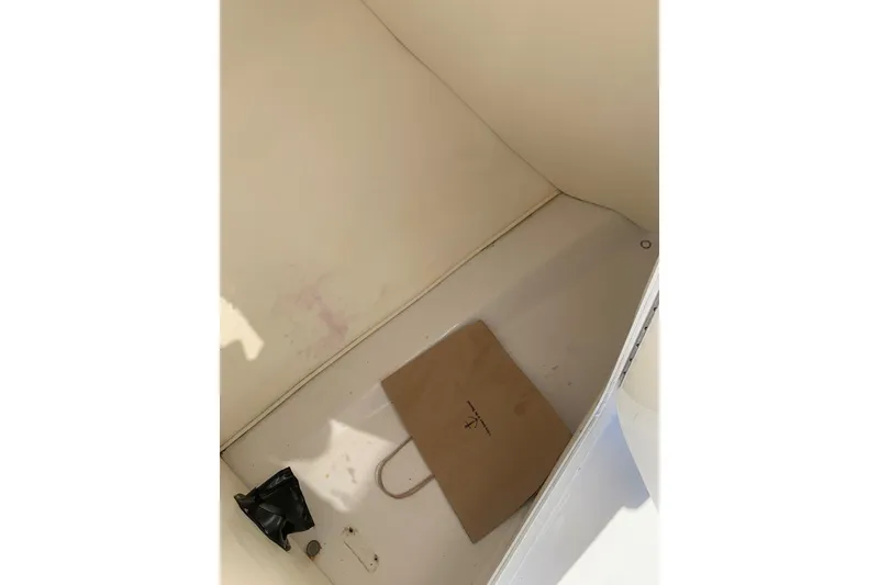 Slide: The Image of Storage compartment of 2003 Four Winns 240 Horizon boat, with a paper bag inside. - 17
