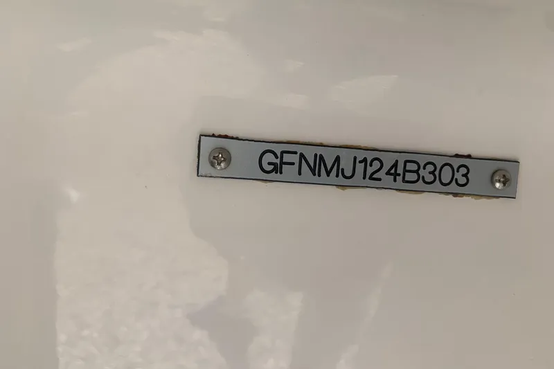 Slide: The Image of 2003 Four Winns 240 Horizon boat identification plate with serial number GFNMJ124B303. - 25