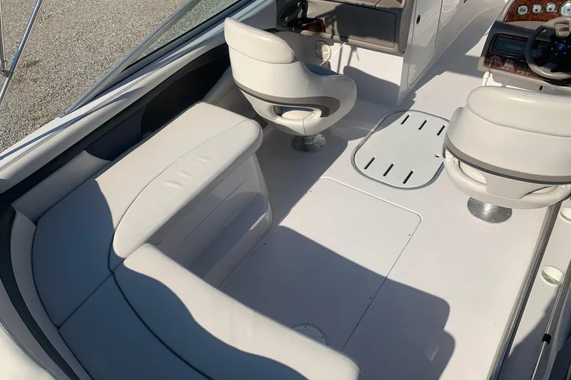 Slide: The Image of 2003 Four Winns 240 Horizon boat interior with white seating and steering console. - 5