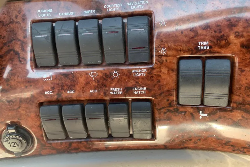 Slide: The Image of Control panel of a 2003 Four Winns 240 Horizon boat with various switches. - 7