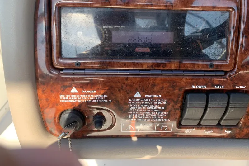 Slide: The Image of 2003 Four Winns 240 Horizon dashboard with warning labels and control switches. - 8