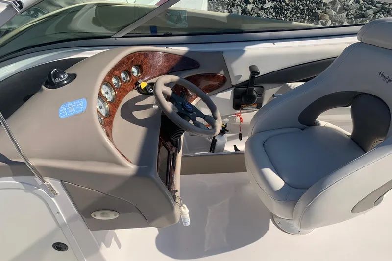 Slide: The Image of 2003 Four Winns 240 Horizon boat cockpit with steering wheel and control panel. - 9