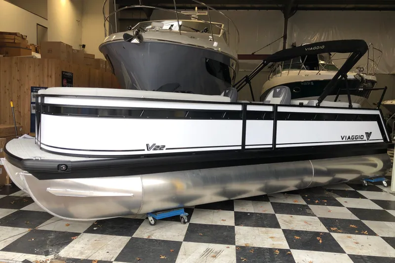 The Image of 2026 Viaggio V22U pontoon boat in showroom, featuring sleek design and modern amenities. - 2