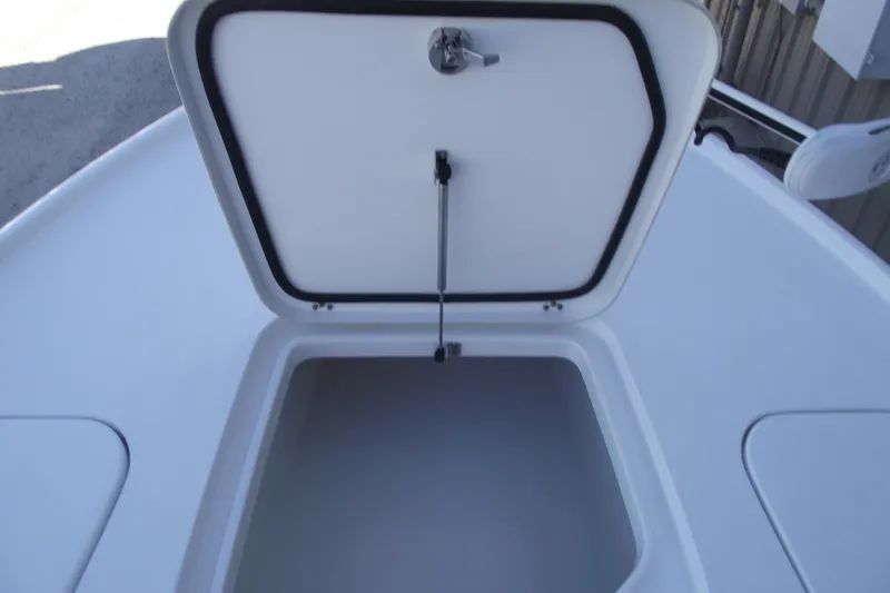 Slide: The Image of 2019 Sea Hunt BX 22 BR boat storage compartment open, showcasing interior space. - 10