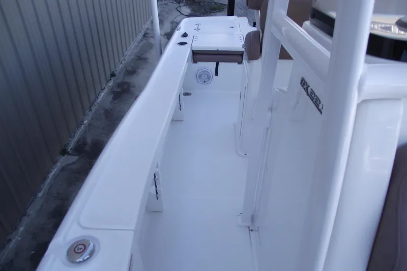 Slide: The Image of 2019 Sea Hunt BX 22 BR boat interior, featuring spacious white deck and seating. - 19