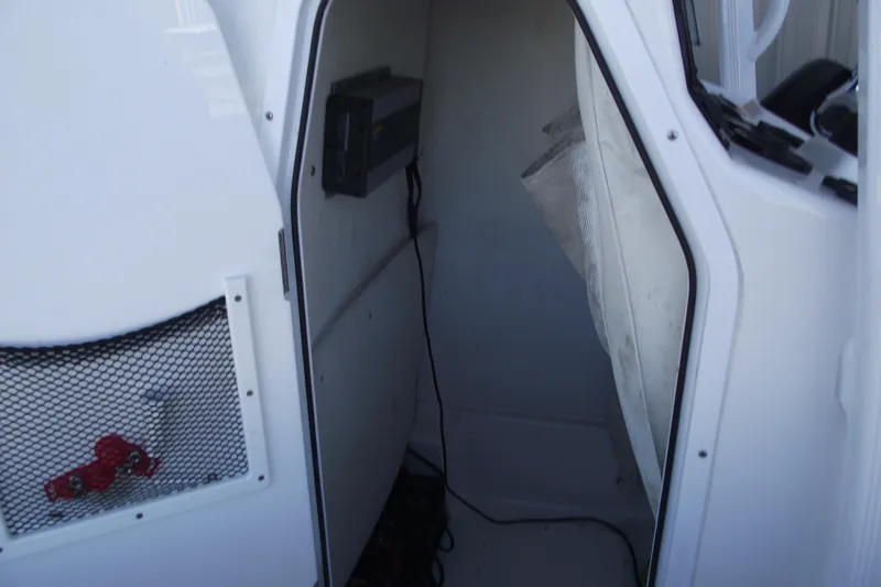 Slide: The Image of 2019 Sea Hunt BX 22 BR interior storage compartment with netted pocket and equipment. - 22