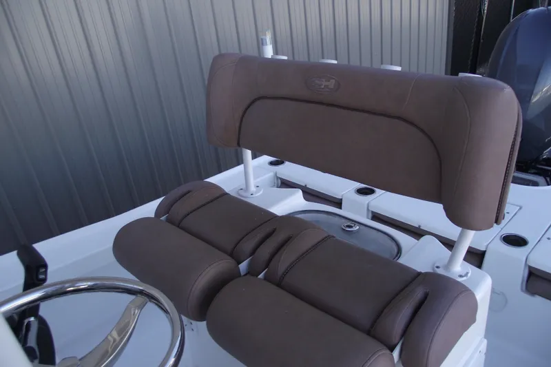 Slide: The Image of 2019 Sea Hunt BX 22 BR boat seat with brown upholstery and steering wheel. - 24
