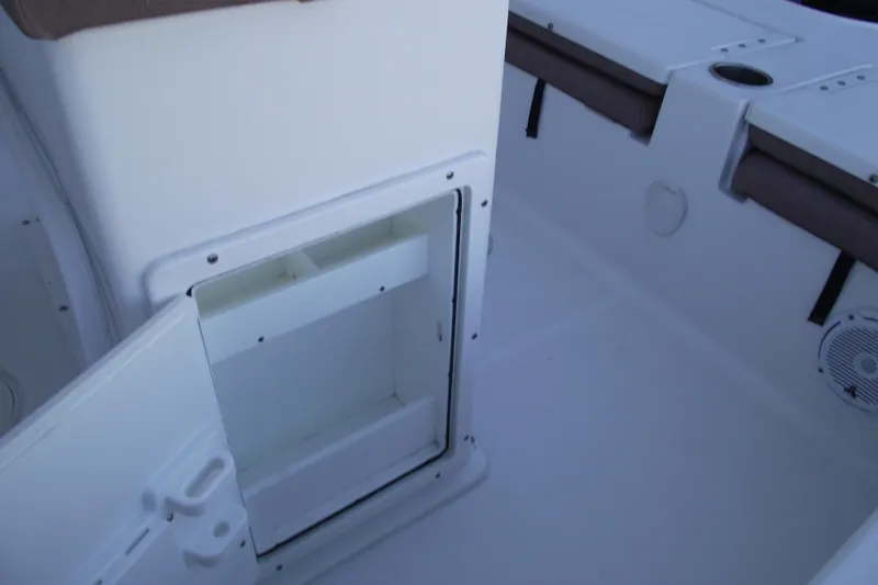 Slide: The Image of 2019 Sea Hunt BX 22 BR boat interior storage compartment with open door. - 33