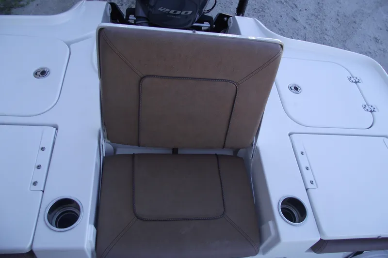 Slide: The Image of 2019 Sea Hunt BX 22 BR boat seating area with cup holders and storage compartments. - 37