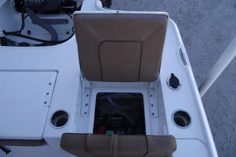 Slide: The Image of 2019 Sea Hunt BX 22 BR boat interior with brown seat and storage compartment. - 43