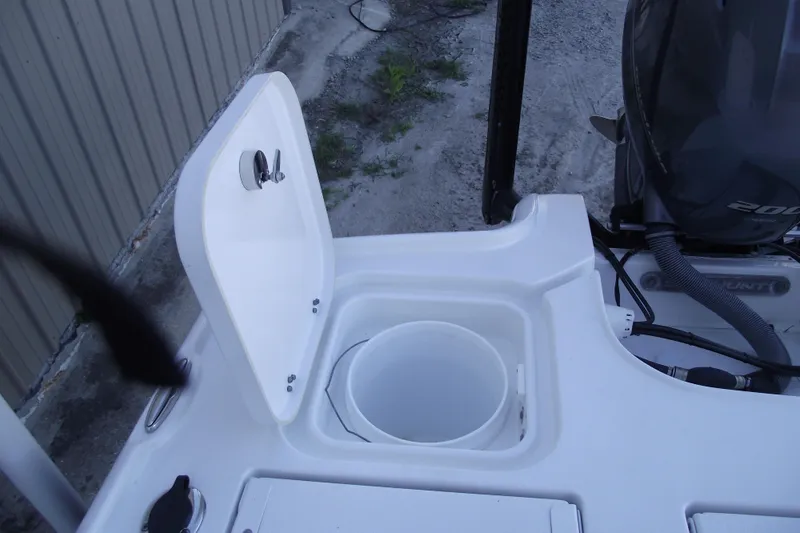 Slide: The Image of 2019 Sea Hunt BX 22 BR boat with open storage compartment and visible engine. - 44