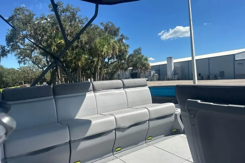 Slide: The Image of 2023 Sea-Doo Switch Cruise 21 interior with gray seating, outdoor setting, and blue sky. - 13