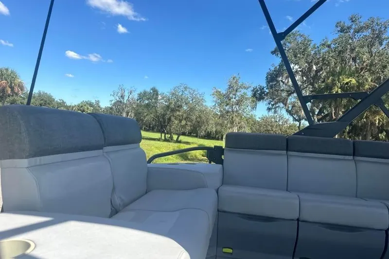 Slide: The Image of 2023 Sea-Doo Switch Cruise 21 interior with comfortable seating, set against a scenic outdoor backdrop. - 14