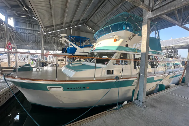 The Image of 1972 Tollycraft 42 Tri-Cabin yacht docked in a covered marina. - 0