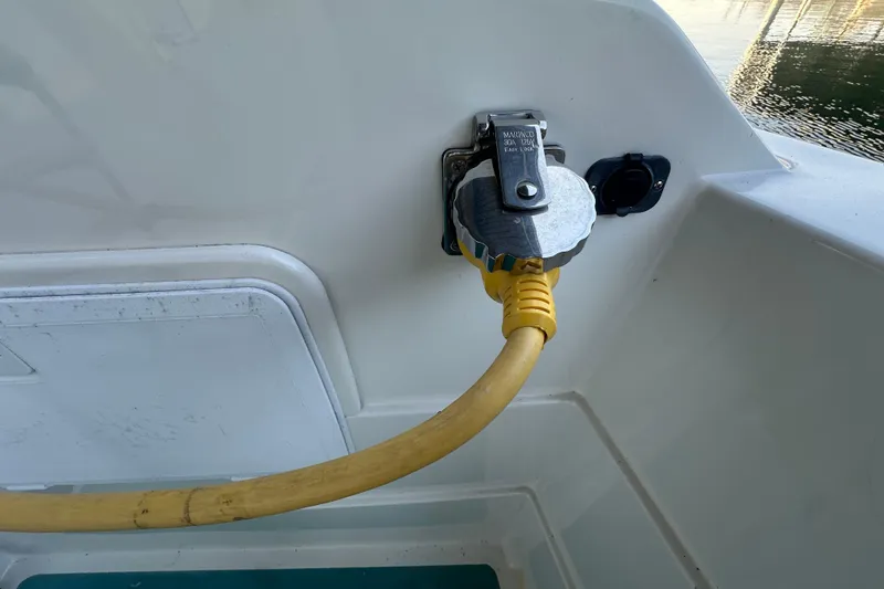 Slide: The Image of Yellow power cable connected to a 1972 Tollycraft 42 Tri-Cabin boat's electrical outlet. - 11