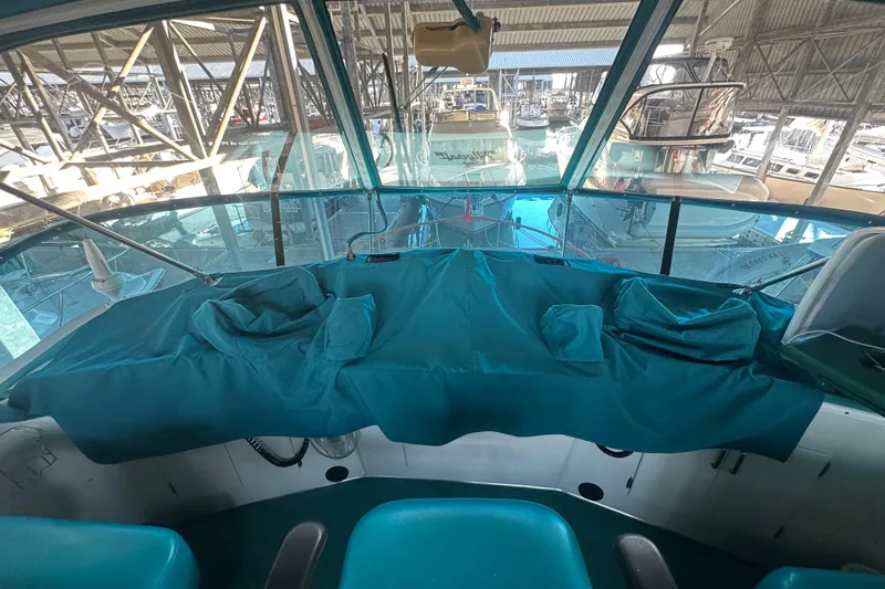Slide: The Image of Interior view of a 1972 Tollycraft 42 Tri-Cabin yacht helm with teal covers. - 17
