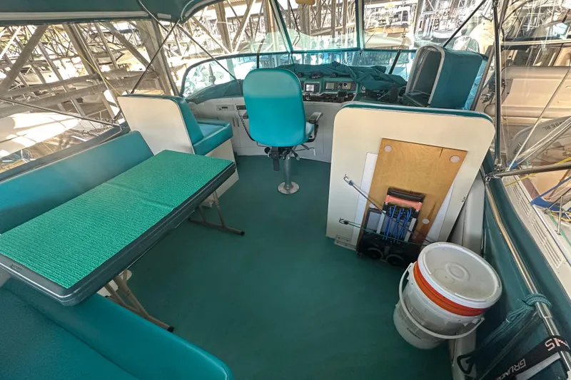 Slide: The Image of 1972 Tollycraft 42 Tri-Cabin boat interior with teal seating and helm station. - 19