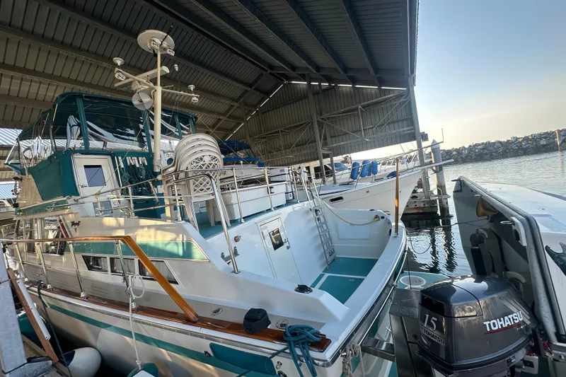 Slide: The Image of 1972 Tollycraft 42 Tri-Cabin yacht docked under a covered marina. - 2