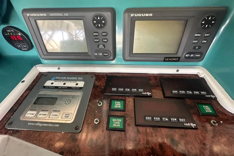 Slide: The Image of Control panel of a 1972 Tollycraft 42 Tri-Cabin with navigation and monitoring systems. - 22