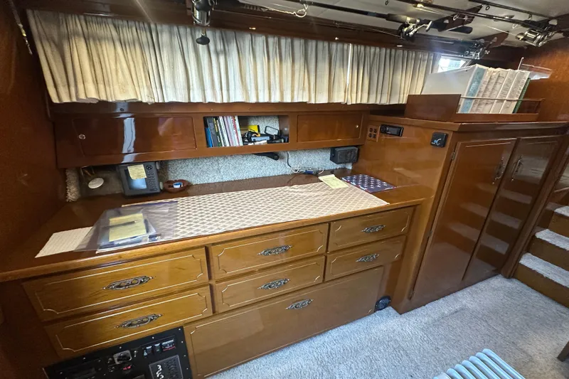 Slide: The Image of 1972 Tollycraft 42 Tri-Cabin interior with wooden cabinetry and storage space. - 28