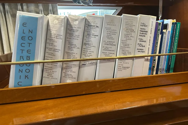 Slide: The Image of Binders and manuals on a Tollycraft 42 Tri-Cabin yacht shelf, 1972 model. - 29