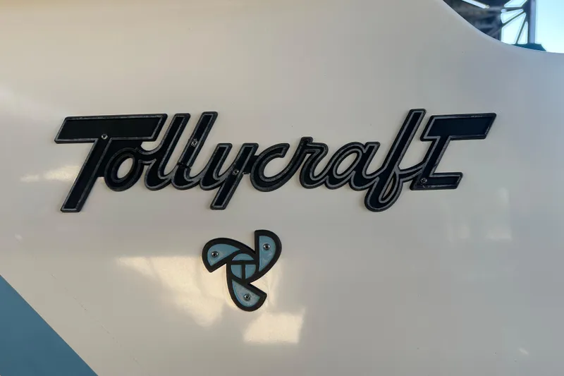 Slide: The Image of 1972 Tollycraft 42 Tri-Cabin logo on boat hull, featuring distinctive emblem. - 3