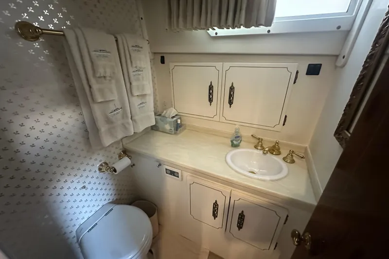 Slide: The Image of Bathroom in 1972 Tollycraft 42 Tri-Cabin yacht with sink, toilet, and towels. - 32