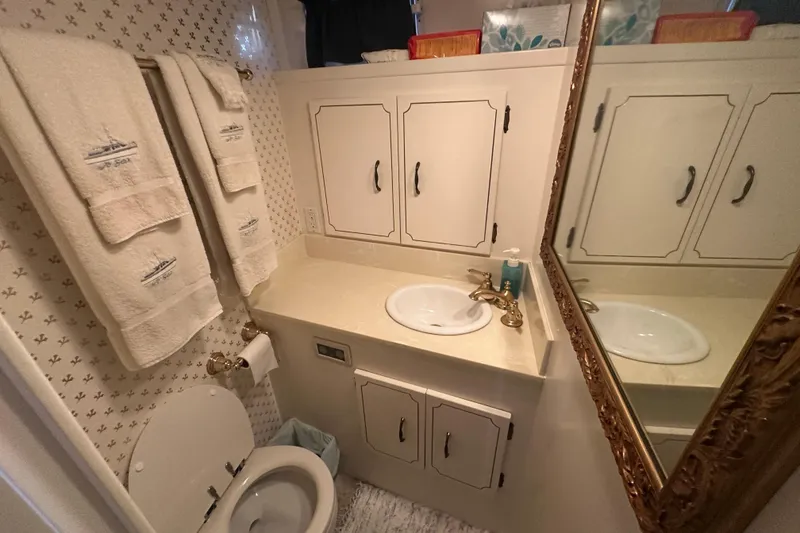 Slide: The Image of Bathroom interior of 1972 Tollycraft 42 Tri-Cabin with sink, mirror, and towels. - 35