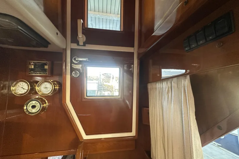 Slide: The Image of Interior of 1972 Tollycraft 42 Tri-Cabin with wooden door and nautical instruments. - 36