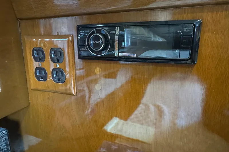Slide: The Image of Kenwood stereo and outlets on Tollycraft 42 Tri-Cabin, 1972 wooden interior. - 51
