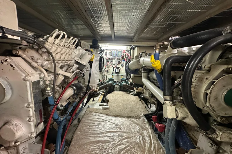 Slide: The Image of Engine room of 1972 Tollycraft 42 Tri-Cabin yacht, showcasing mechanical components and piping. - 55