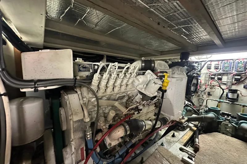 Slide: The Image of Engine room of a 1972 Tollycraft 42 Tri-Cabin boat, showcasing mechanical components. - 56