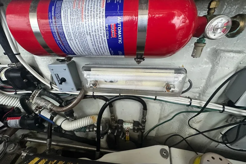 Slide: The Image of Engine room of 1972 Tollycraft 42 Tri-Cabin with fire extinguisher and wiring. - 57