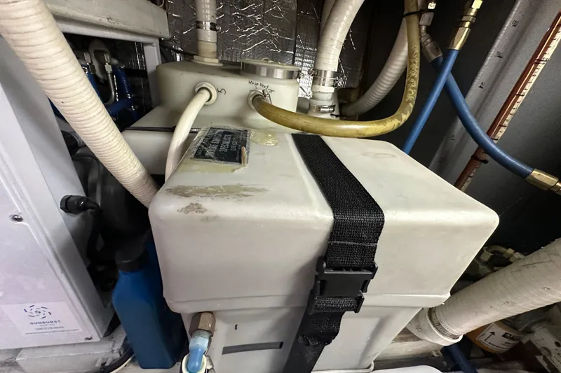 Slide: The Image of Engine compartment of 1972 Tollycraft 42 Tri-Cabin with hoses and equipment. - 58