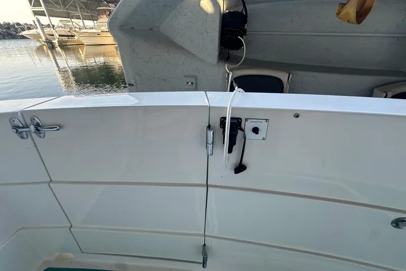 Slide: The Image of 1972 Tollycraft 42 Tri-Cabin boat deck with latch and lift mechanism, docked at marina. - 6