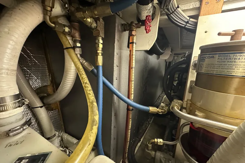 Slide: The Image of Engine room of 1972 Tollycraft 42 Tri-Cabin with hoses and Racor filter system. - 61