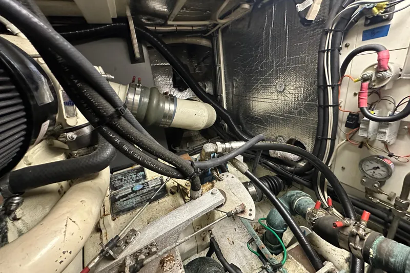 Slide: The Image of Engine room of a 1972 Tollycraft 42 Tri-Cabin with visible hoses and wiring. - 65