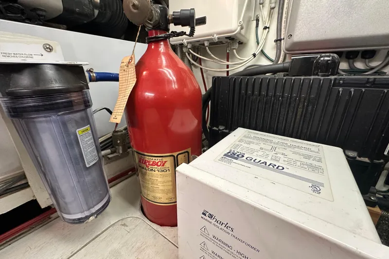 Slide: The Image of Engine room of 1972 Tollycraft 42 Tri-Cabin with fire extinguisher and marine equipment. - 70