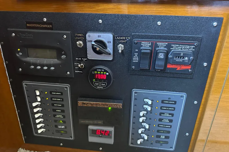 Slide: The Image of Electrical control panel on a 1972 Tollycraft 42 Tri-Cabin boat, featuring various switches and gauges. - 72