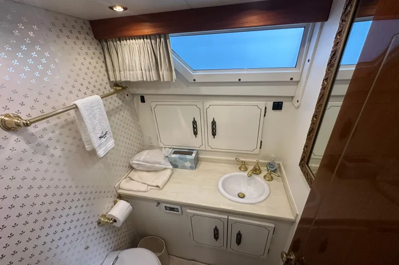 Slide: The Image of Bathroom interior of 1972 Tollycraft 42 Tri-Cabin yacht with sink, cabinets, and window. - 74