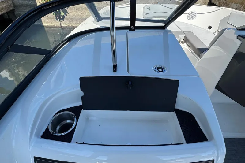 Slide: The Image of 2022 Bayliner VR6 Bowrider OB interior with cup holder and storage compartment. - 11