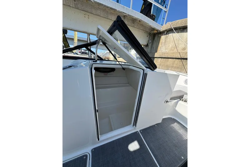 Slide: The Image of 2022 Bayliner VR6 Bowrider OB interior cabin with open door and seating area. - 17